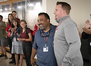 Principal Dunham hugs Pride of Peoria recipient